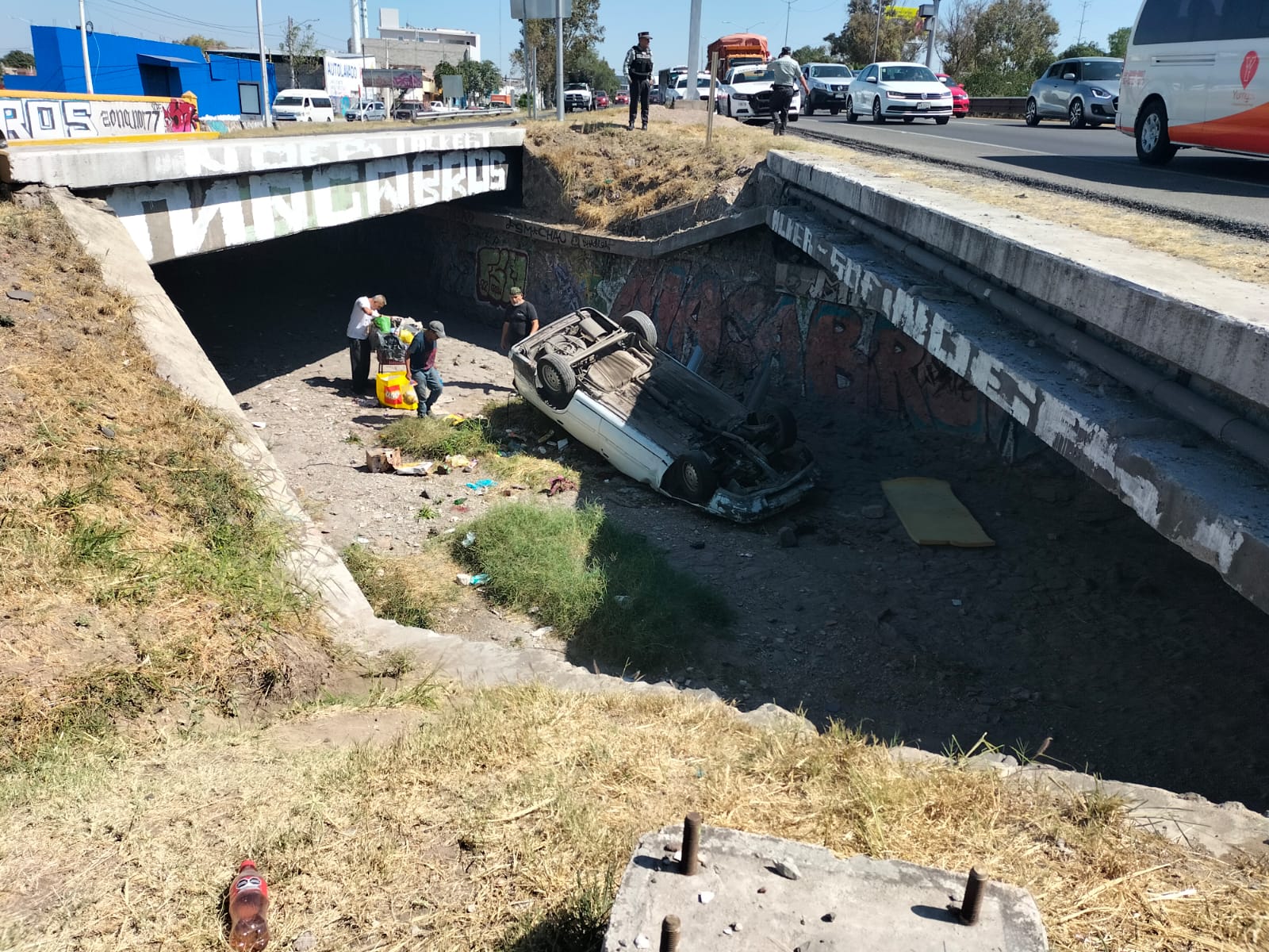 Vuelca vehículo y cae en un dren pluvial